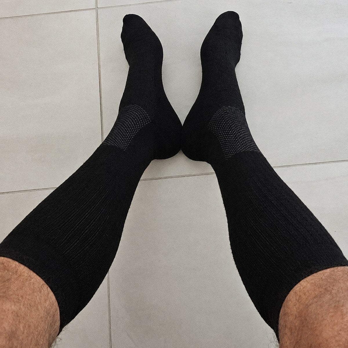 Customer photo from Kevin P. — black compression socks worn at home, seen from above